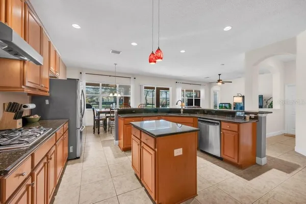 a kitchen with stainless steel appliances granite countertop a sink counter space and cabinets