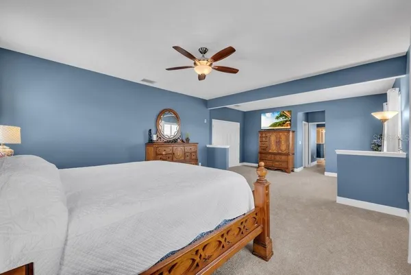 a spacious bathroom with a tub a double vanity sink a mirror and a shower