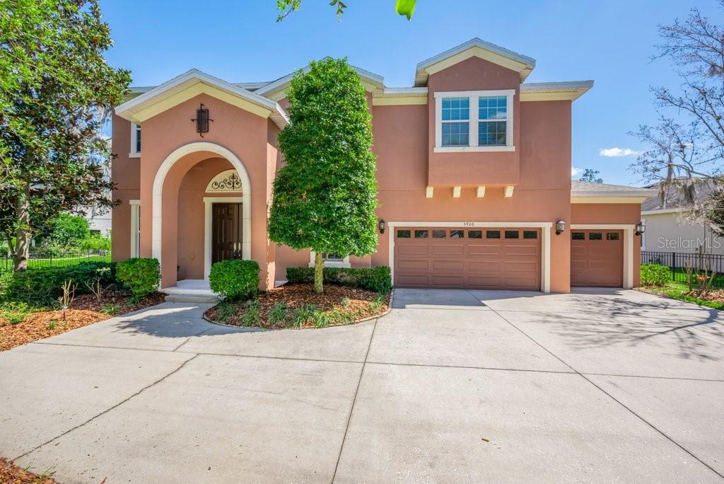 5920 Fishhawk Crossing Boulevard Lithia, FL 33547 - Photo 3 of 61 a front view of a house with a yard and garage