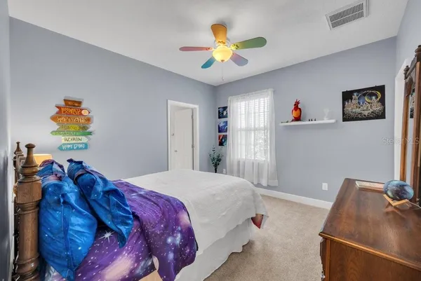 a bedroom with a large bed and a large window