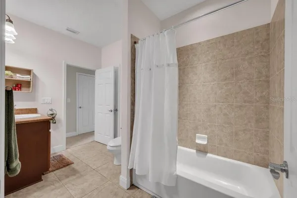 an empty room with a window and a ceiling fan