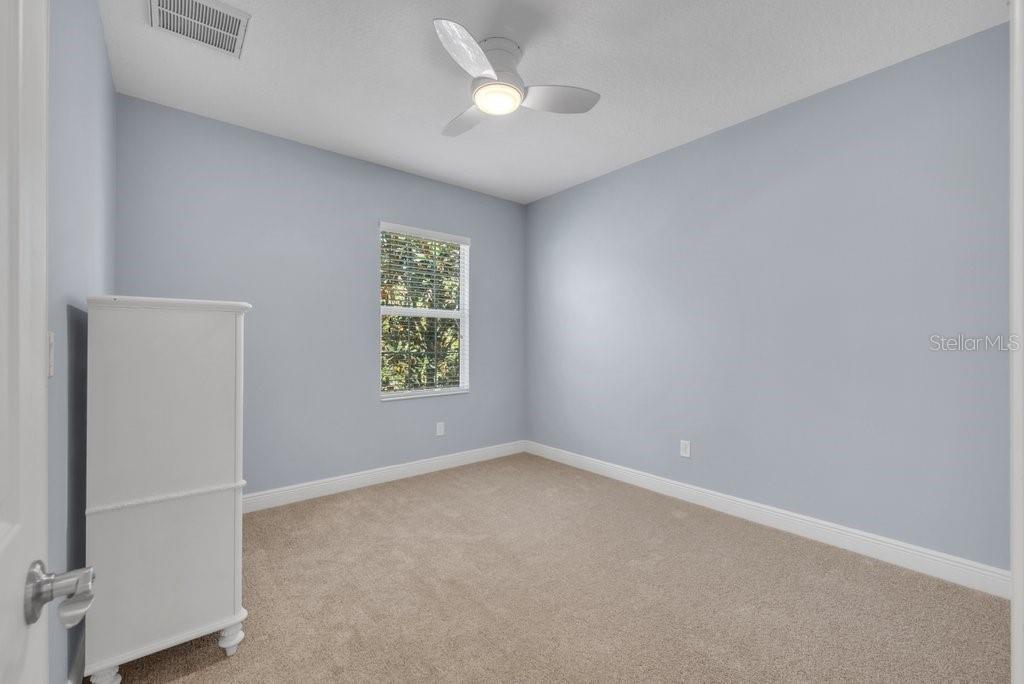 5920 Fishhawk Crossing Boulevard Lithia, FL 33547 - Photo 36 of 61 an empty room with a window and a ceiling fan