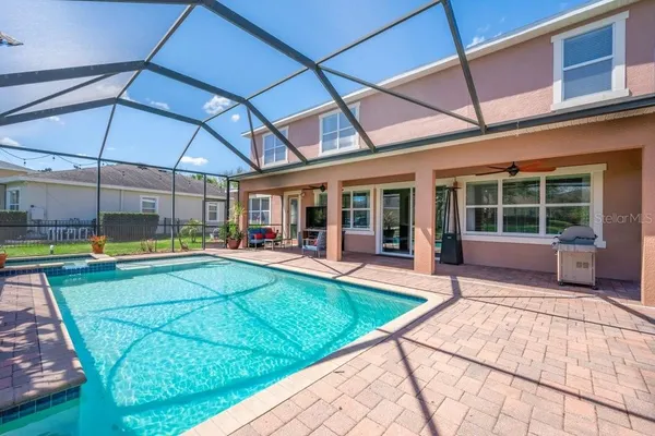 an aerial view of a house with swimming pool and garden