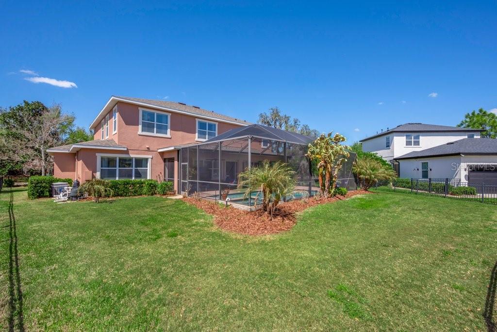 5920 Fishhawk Crossing Boulevard Lithia, FL 33547 - Photo 45 of 61 a front view of a house with a garden and plants
