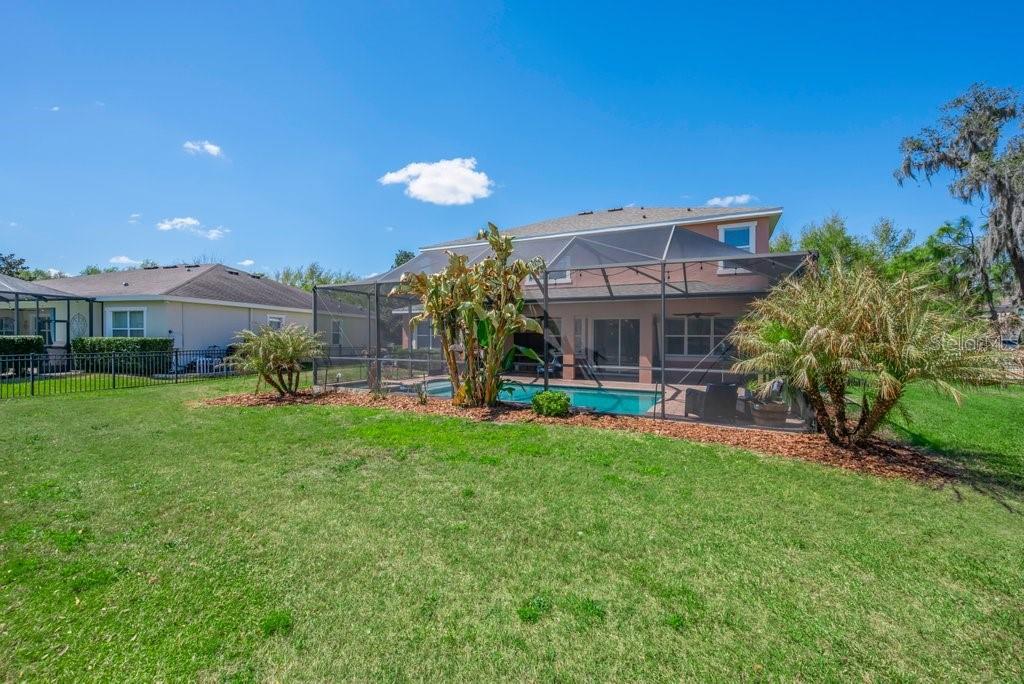 5920 Fishhawk Crossing Boulevard Lithia, FL 33547 - Photo 46 of 61 a view of a house with backyard sitting area and garden