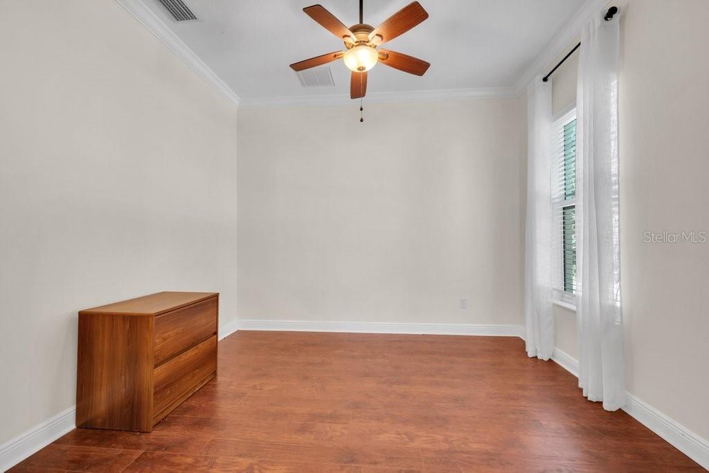 5920 Fishhawk Crossing Boulevard Lithia, FL 33547 - Photo 8 of 61 a view of an empty room with window and wooden floor