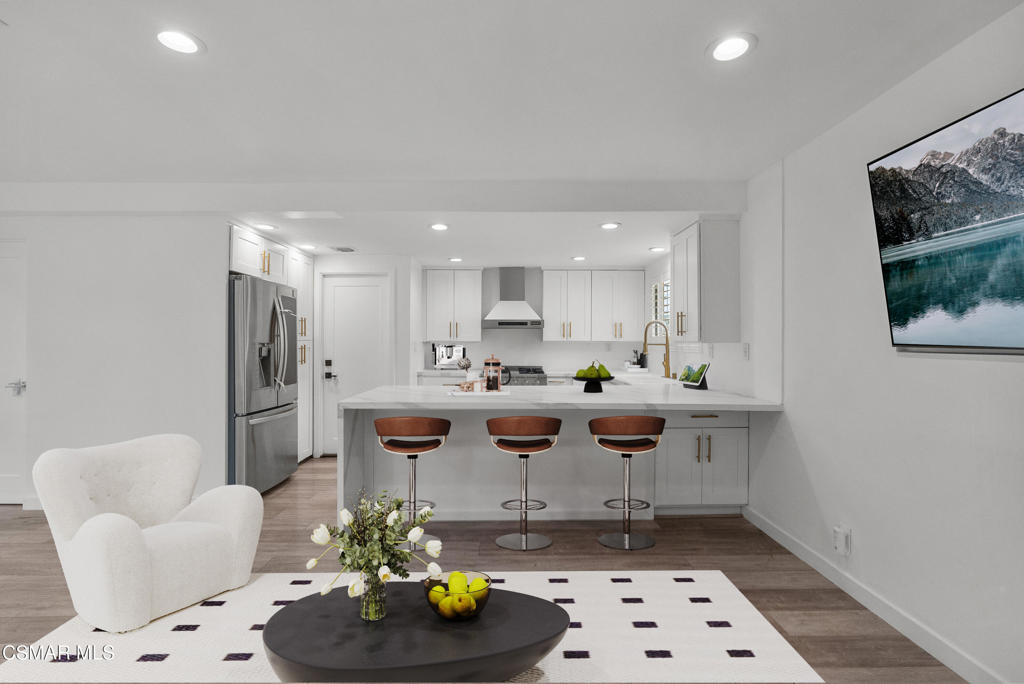 264 Beech Road Newbury Park, CA 91320 - Photo 7 of 29 a kitchen with stainless steel appliances kitchen island granite countertop a sink and a refrigerator