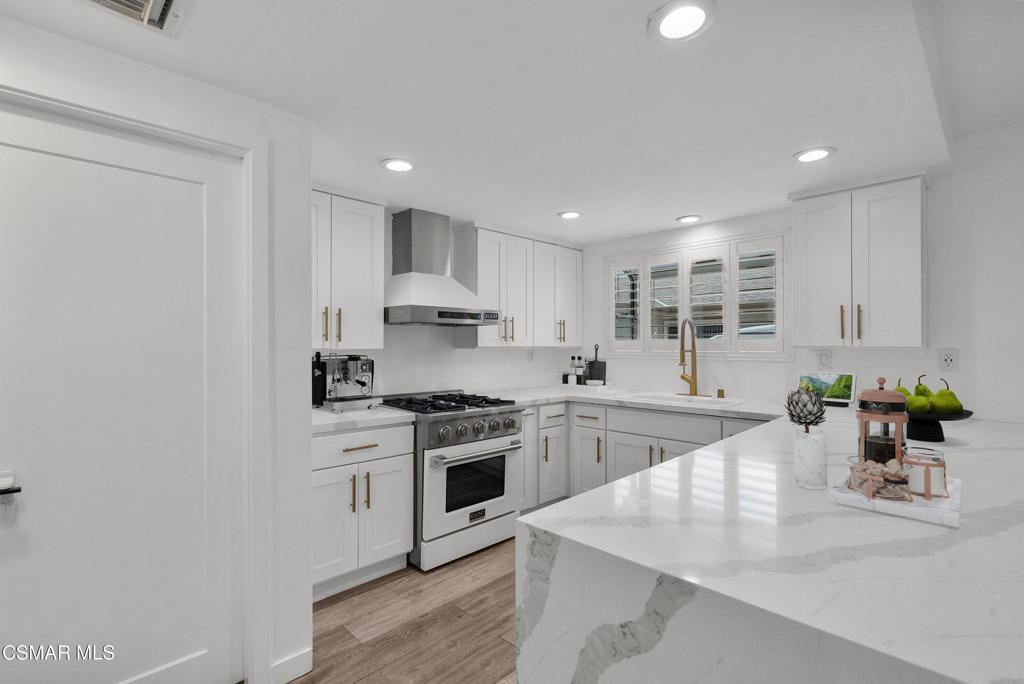 264 Beech Road Newbury Park, CA 91320 - Photo 8 of 29 a kitchen with a stove a sink and a refrigerator