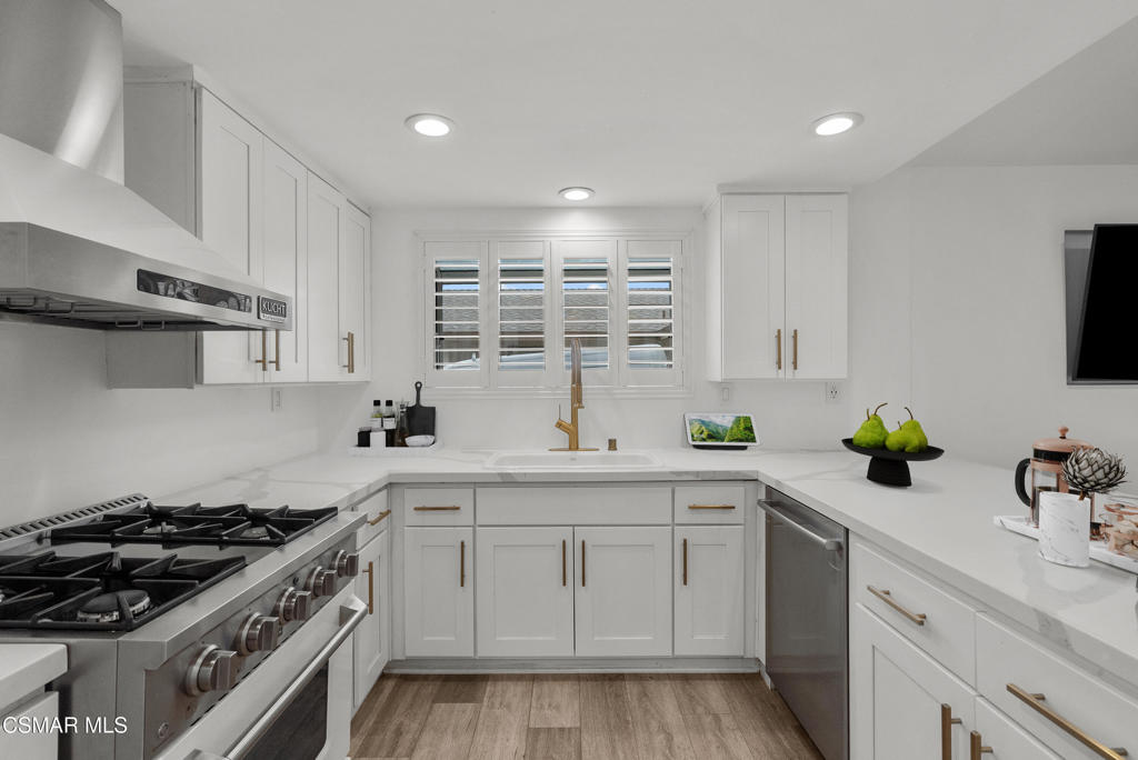 264 Beech Road Newbury Park, CA 91320 - Photo 9 of 29 a kitchen with a sink stove and cabinets