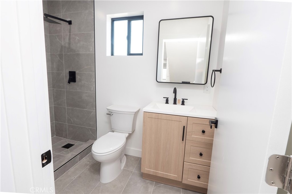 1571 Ricardo Street Los Angeles, CA 90033 - Photo 17 of 29 a bathroom with a toilet sink vanity and mirror