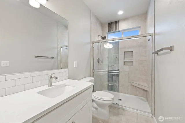 a bathroom with a sink toilet and shower