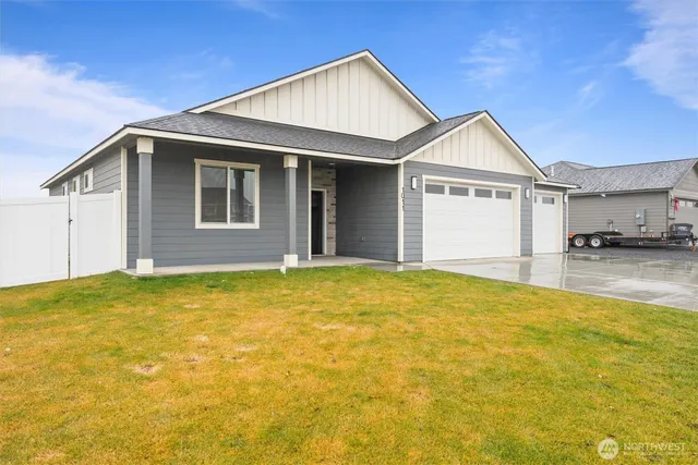 a view of a house with a yard and garage