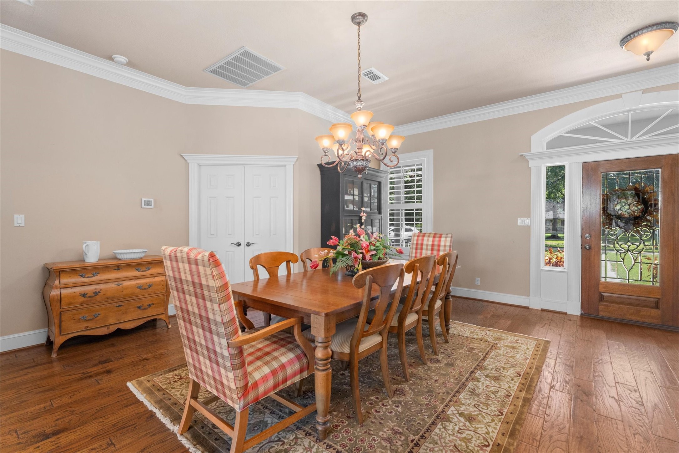31627 Cedardale Street Magnolia, TX 77355 - Photo 13 of 47 The dining room features beautiful floors, crown molding, chandelier, and plenty of natural light.