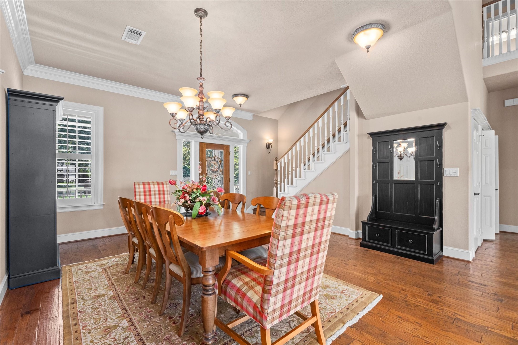 31627 Cedardale Street Magnolia, TX 77355 - Photo 14 of 47 The dining room features beautiful floors, crown molding, chandelier, and plenty of natural light.