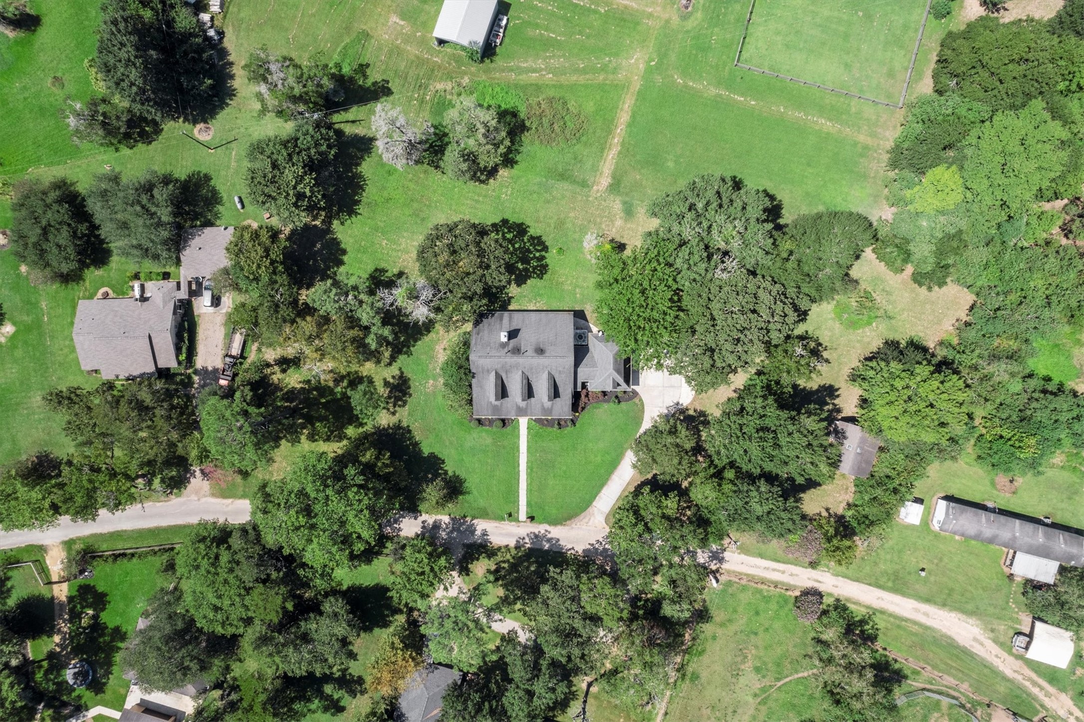 31627 Cedardale Street Magnolia, TX 77355 - Photo 4 of 47 A custom-built traditional home nestled on a spacious lot, surrounded by mature trees and natural privacy.