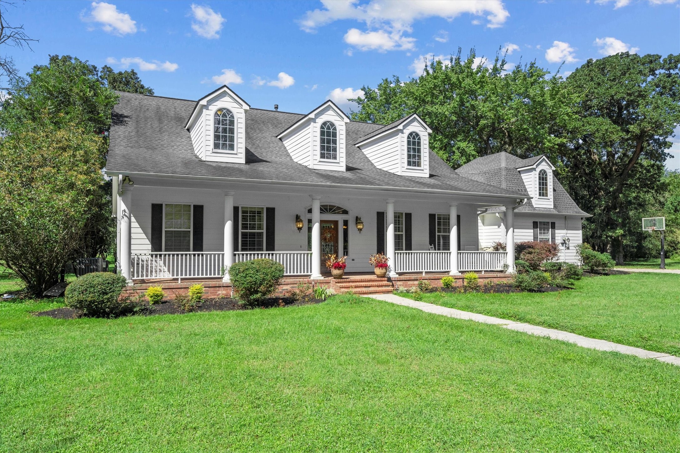 31627 Cedardale Street Magnolia, TX 77355 - Photo 5 of 47 Covered entryway with shutters on the windows and a warm first impression.