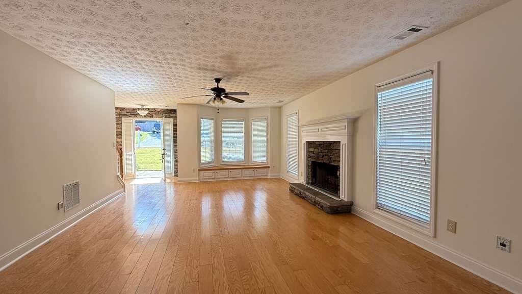3860 Morgan Road Buford, GA 30519 - Photo 18 of 21 wooden floor in an empty room with a window