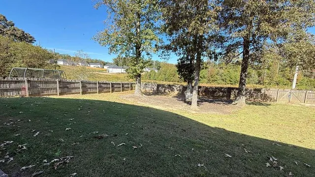 a view of a house with garden and sitting area