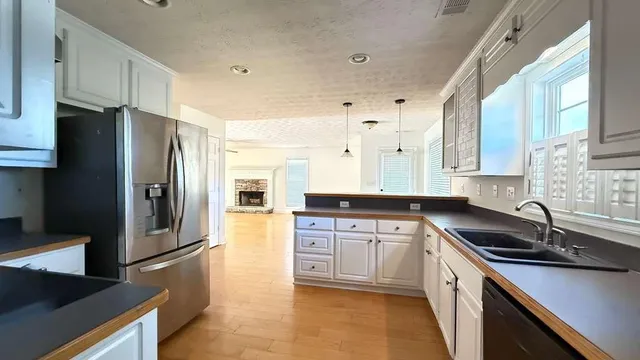 a kitchen with stainless steel appliances a refrigerator sink and microwave