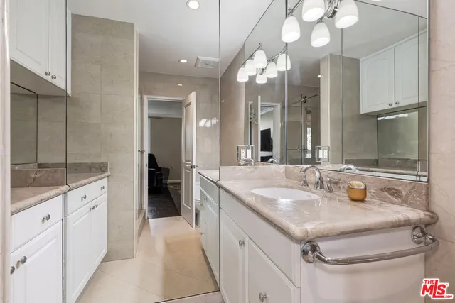 a bathroom with sinks a vanity and a large mirror