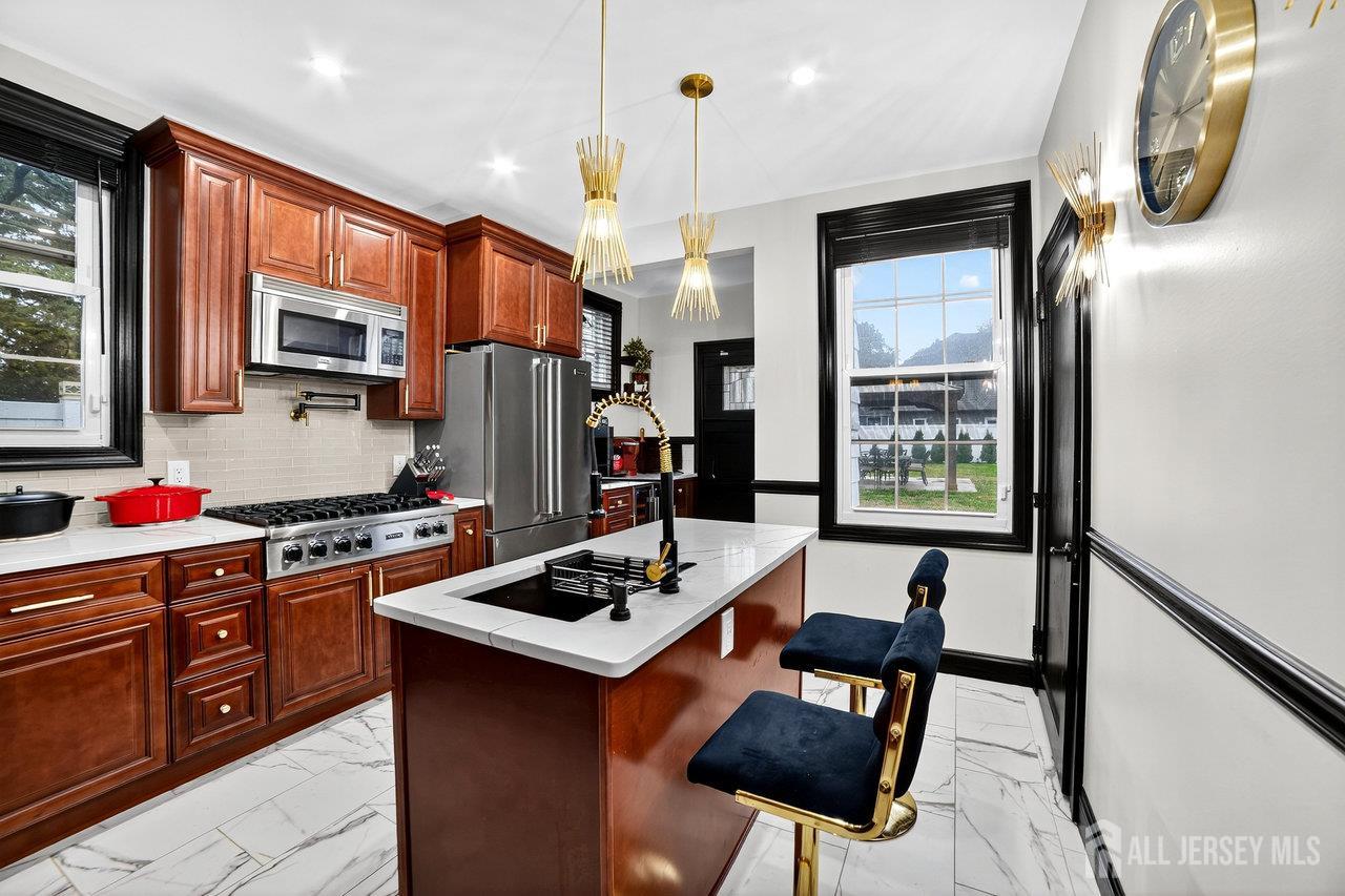 101 West Hill Road Colonia, NJ 07067 - Photo 14 of 52 a kitchen with stainless steel appliances granite countertop a stove refrigerator and a microwave