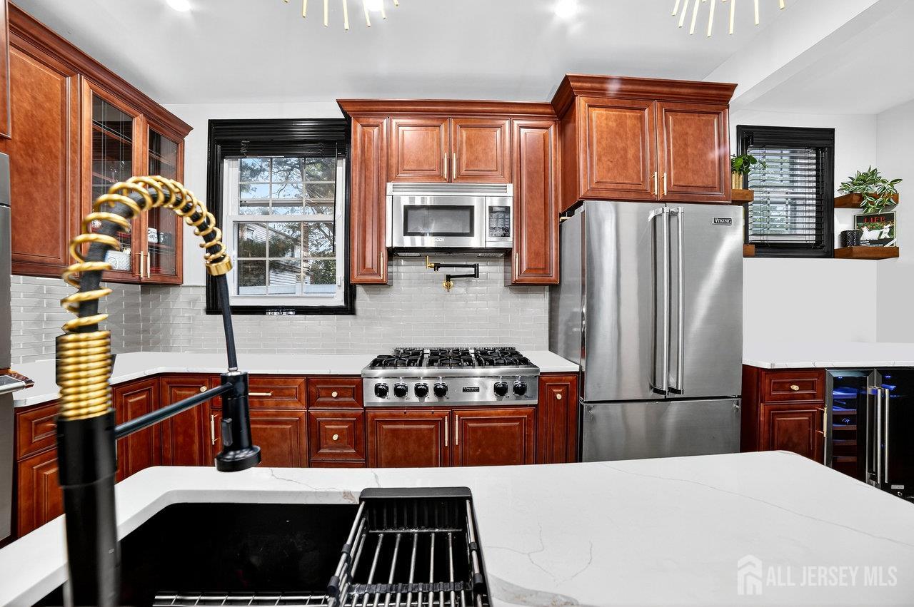 101 West Hill Road Colonia, NJ 07067 - Photo 15 of 52 a kitchen with stainless steel appliances a stove a refrigerator and a sink