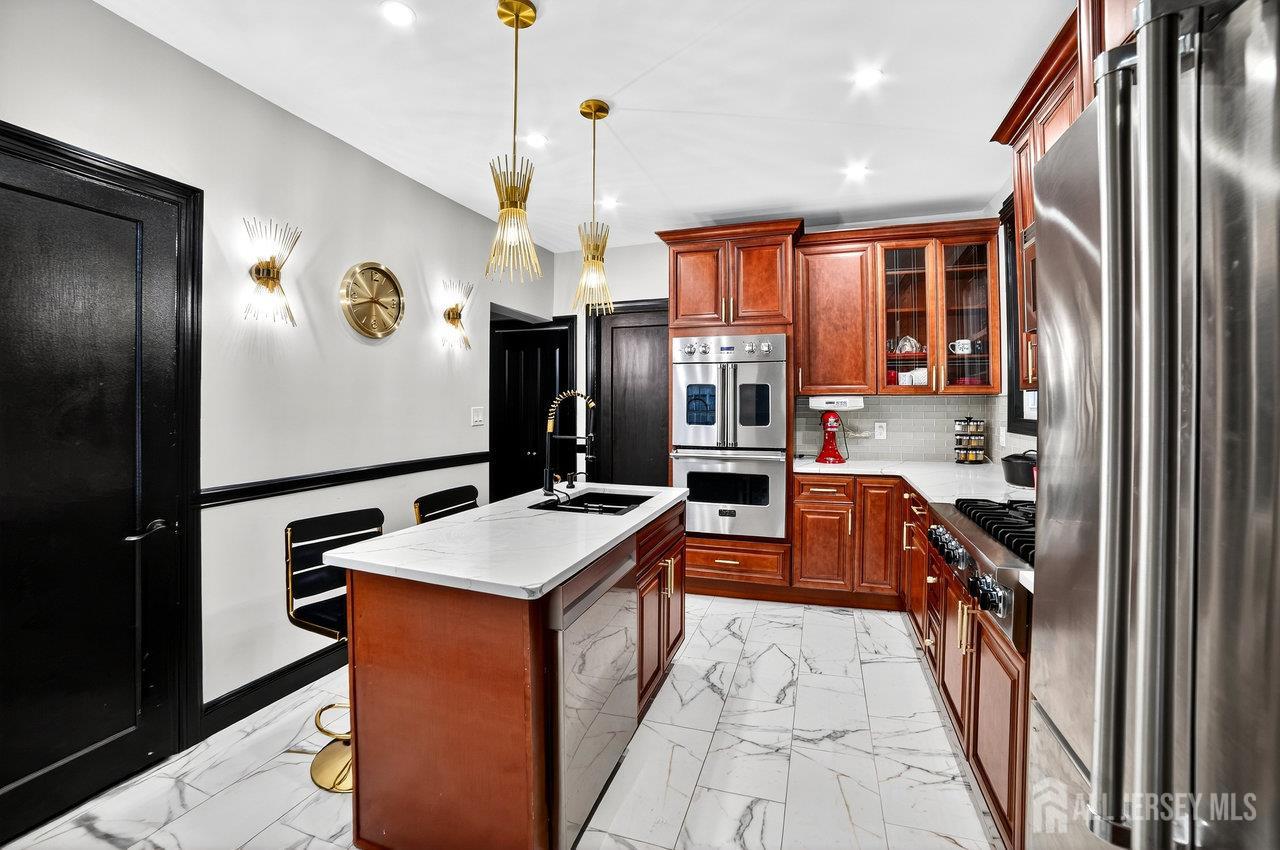 101 West Hill Road Colonia, NJ 07067 - Photo 16 of 52 a kitchen with stainless steel appliances granite countertop refrigerator a sink a stove and dishwasher