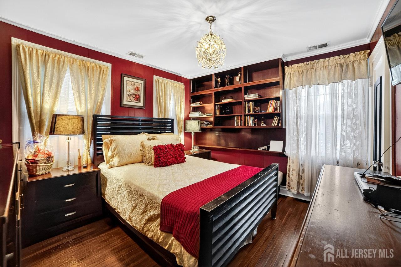 101 West Hill Road Colonia, NJ 07067 - Photo 17 of 52 a bedroom with a bed and large windows