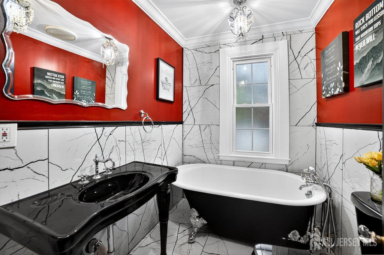 101 West Hill Road Colonia, NJ 07067 - Photo 18 of 52 a bathroom with a sink a mirror and a shower