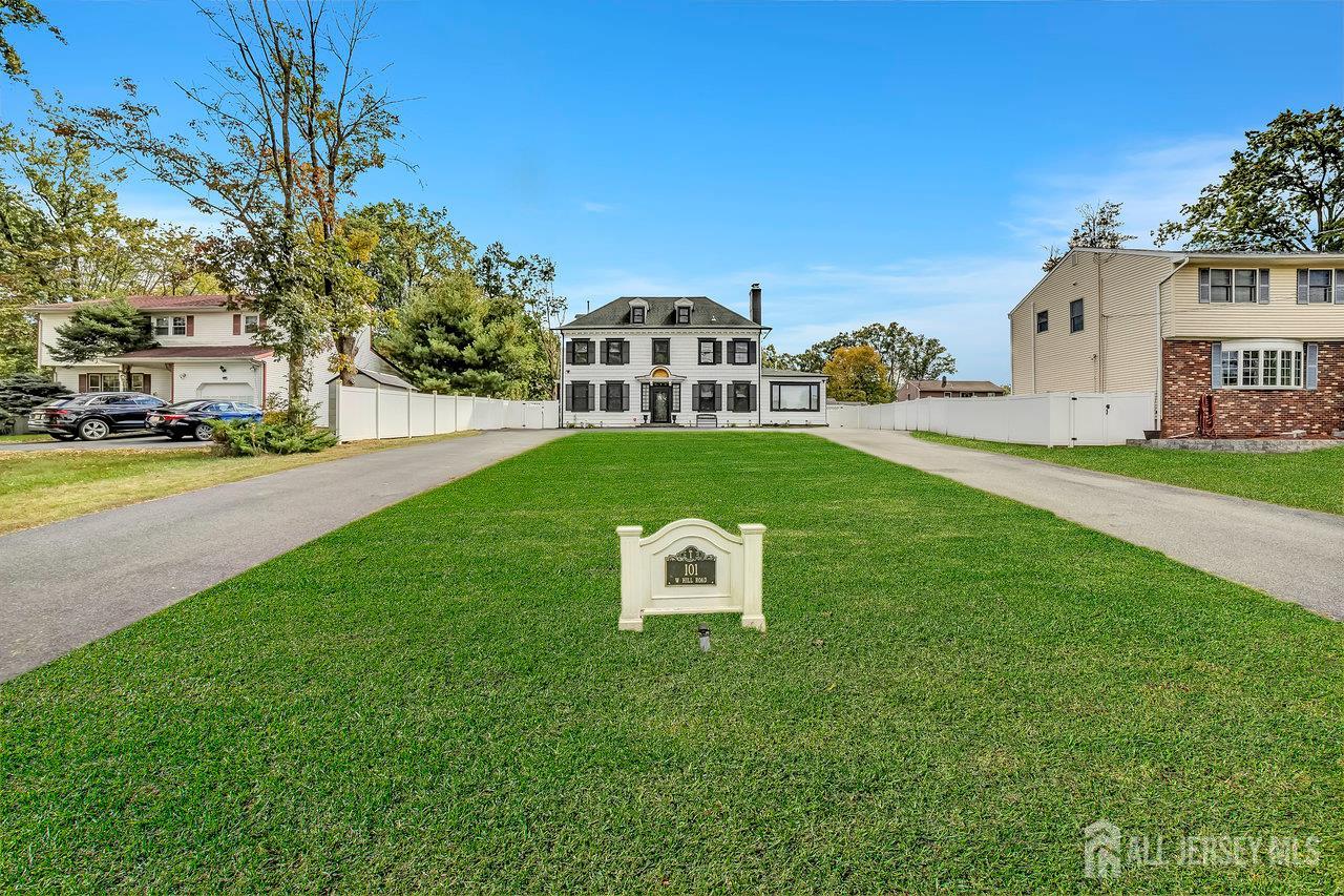 101 West Hill Road Colonia, NJ 07067 - Photo 2 of 52 a front view of a house with a garden