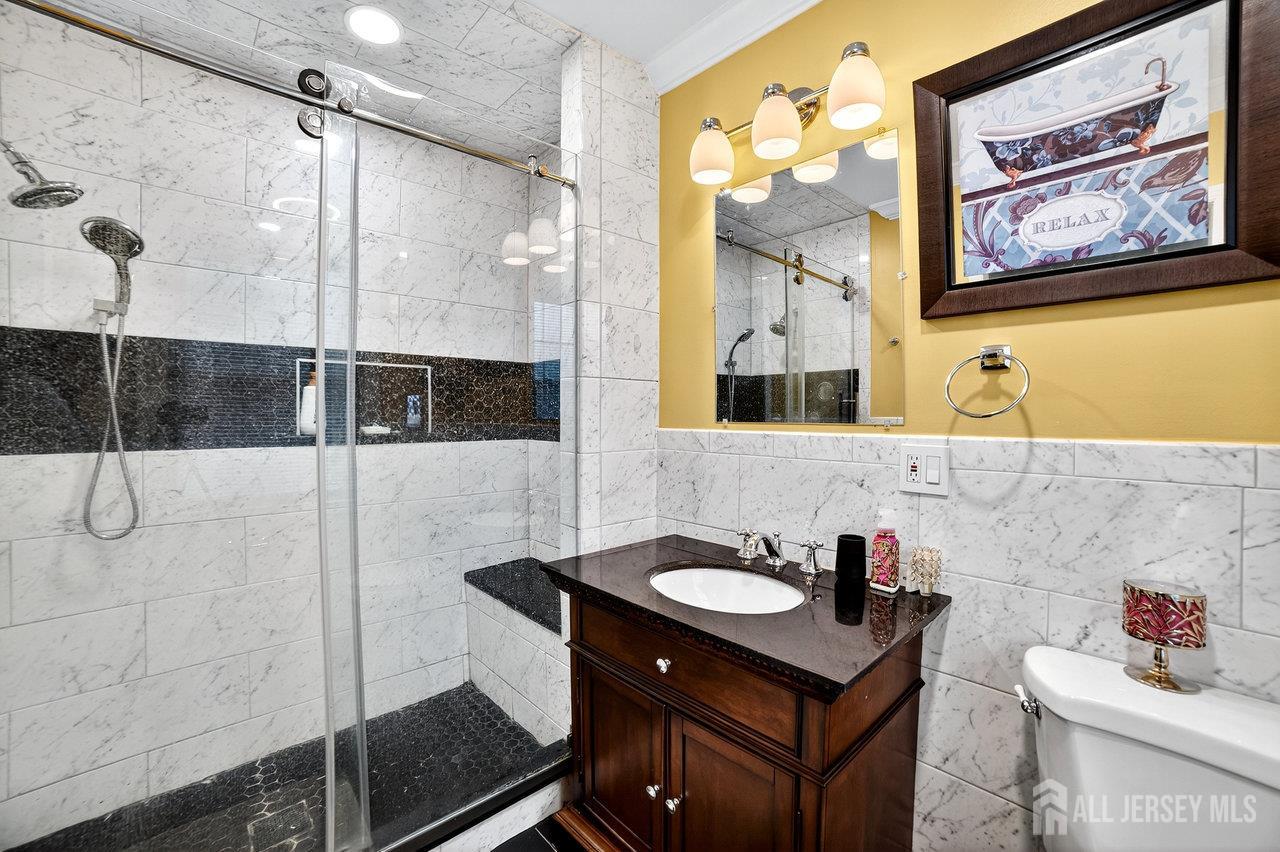 101 West Hill Road Colonia, NJ 07067 - Photo 24 of 52 a bathroom with a sink and a mirror