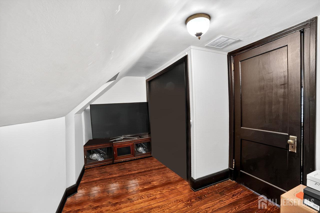 101 West Hill Road Colonia, NJ 07067 - Photo 32 of 52 a living room with a flat screen tv and a rug