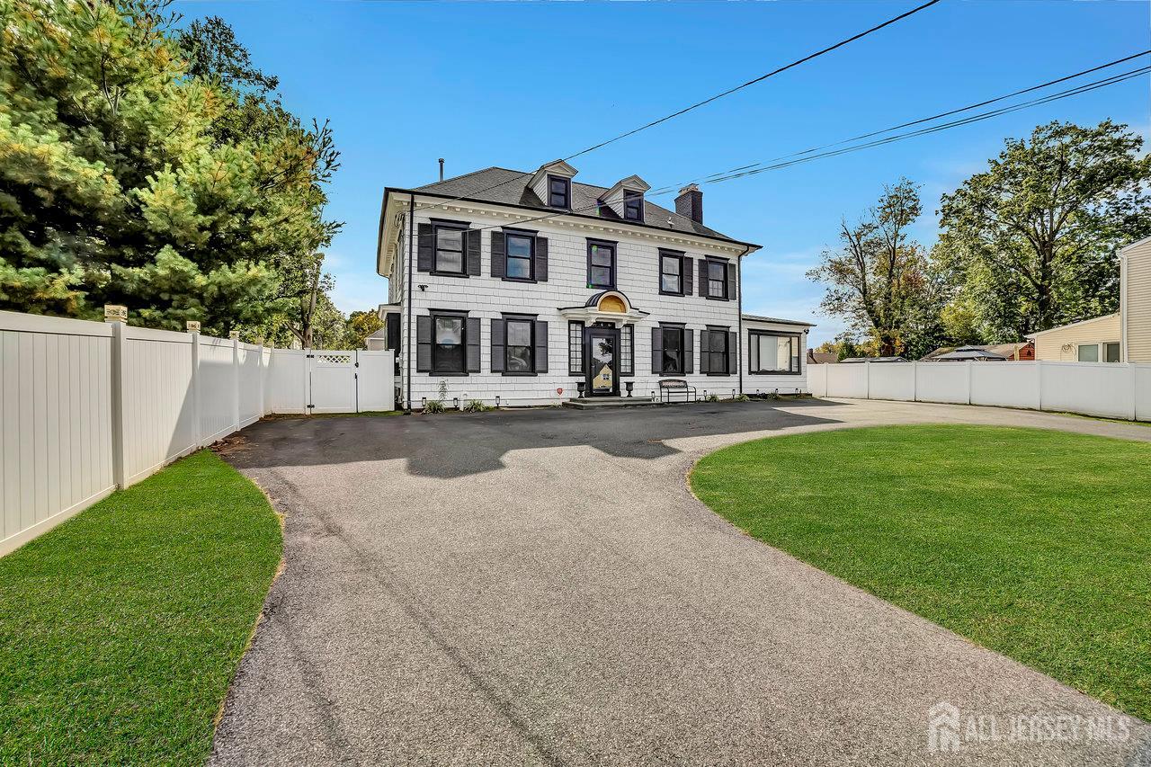 101 West Hill Road Colonia, NJ 07067 - Photo 7 of 52 a front view of a house with a yard table and chairs
