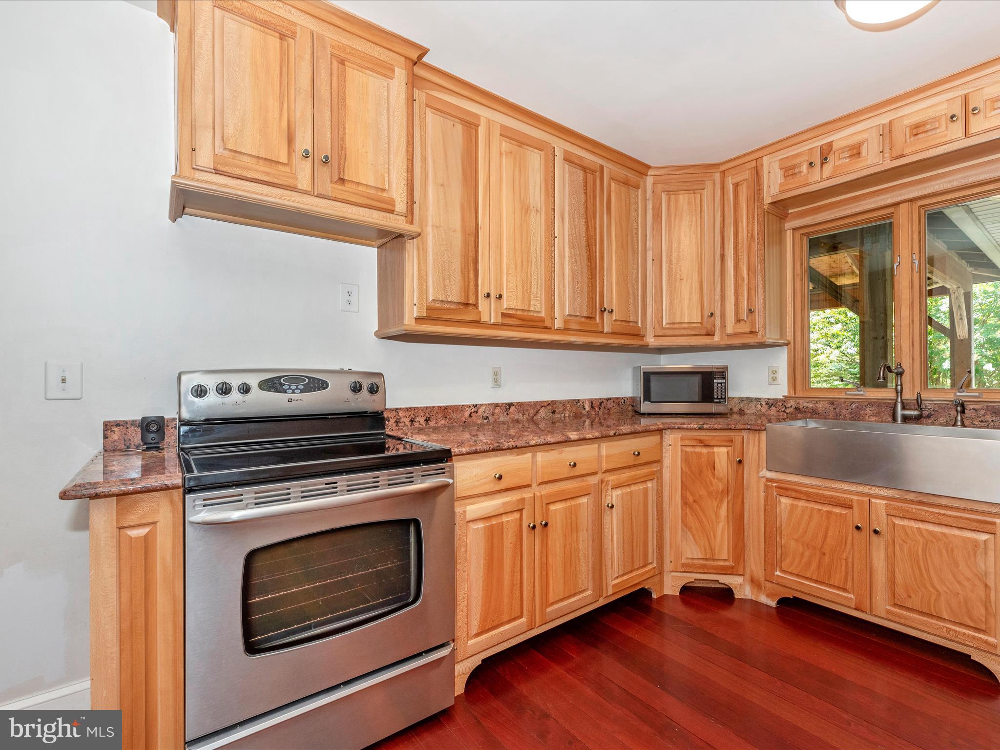 2313 Bidle Road Middletown, MD 21769 - Photo 16 of 85 a kitchen with granite countertop wooden cabinets stainless steel appliances and a sink