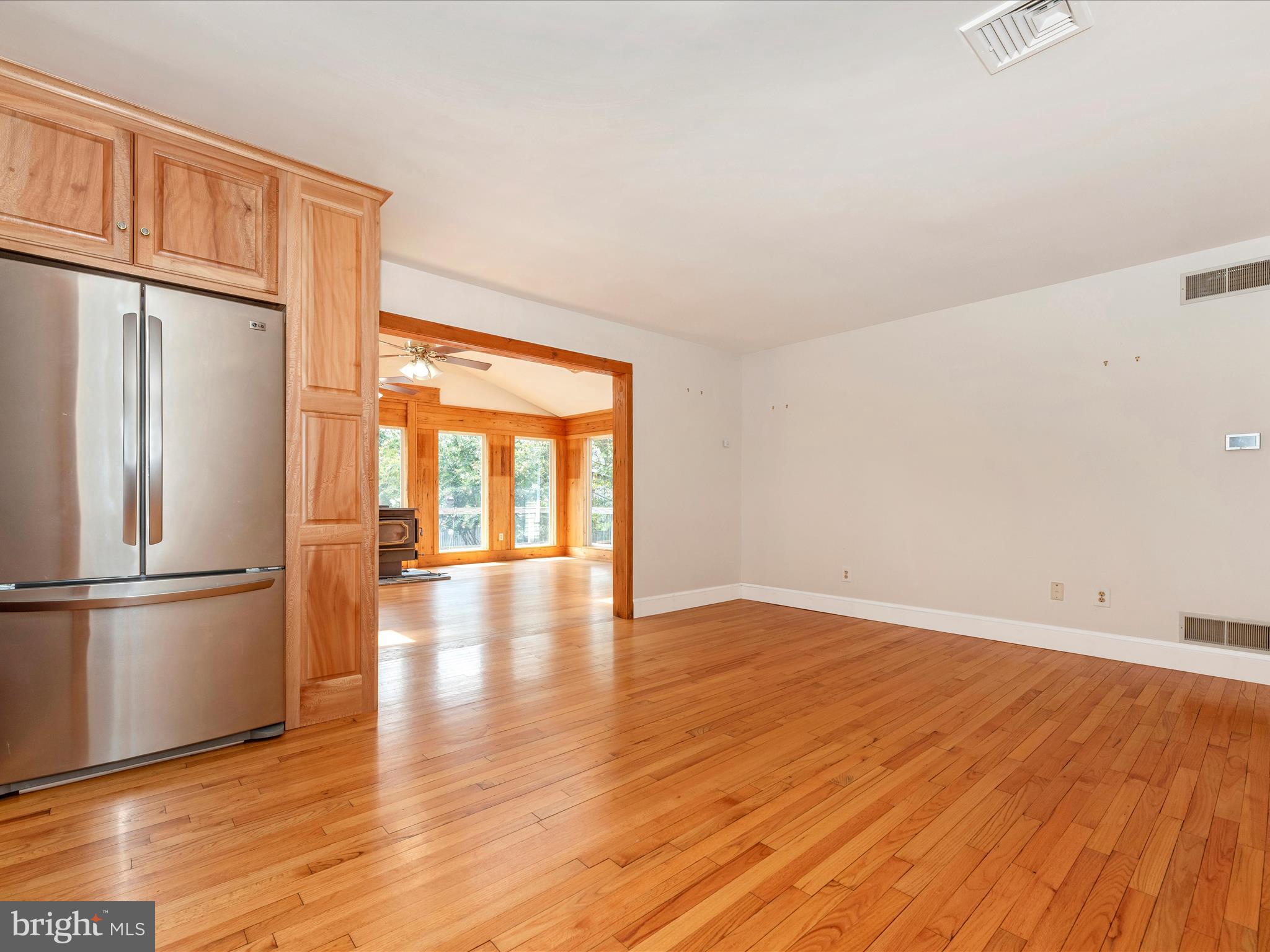 2313 Bidle Road Middletown, MD 21769 - Photo 22 of 85 a view of an empty room with wooden floor and a window