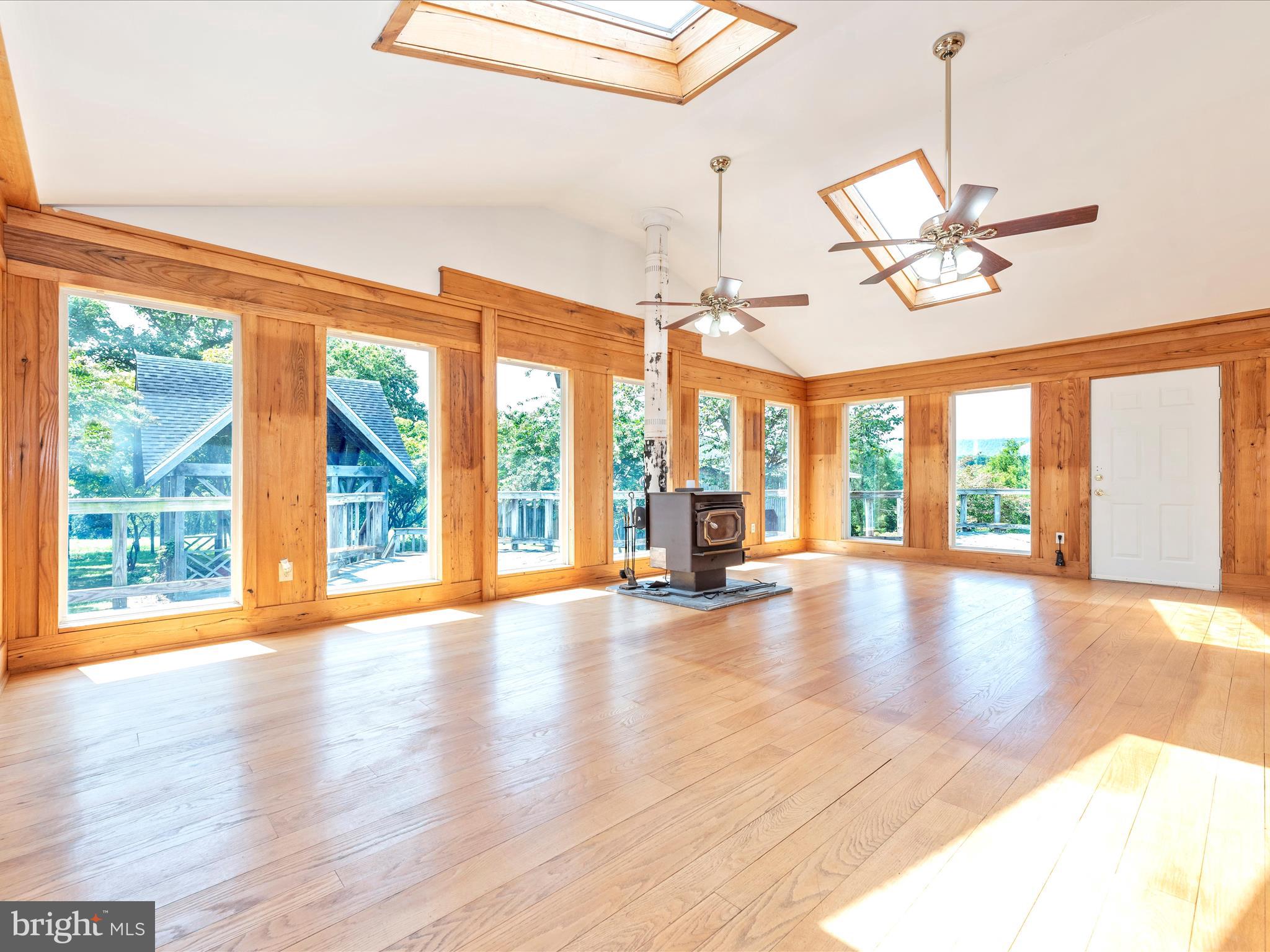 2313 Bidle Road Middletown, MD 21769 - Photo 27 of 85 a view of an empty room with wooden floor and a window