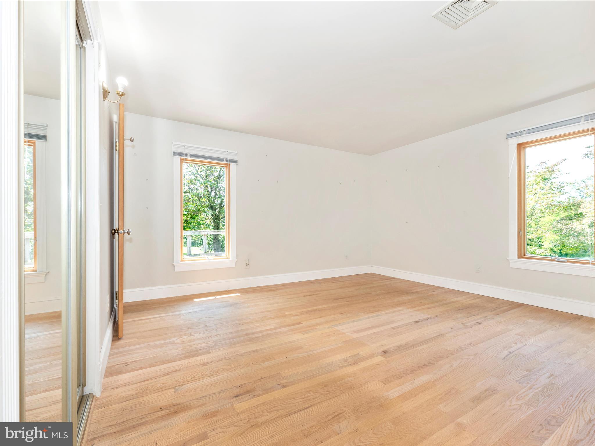 2313 Bidle Road Middletown, MD 21769 - Photo 31 of 85 an empty room with wooden floor and windows