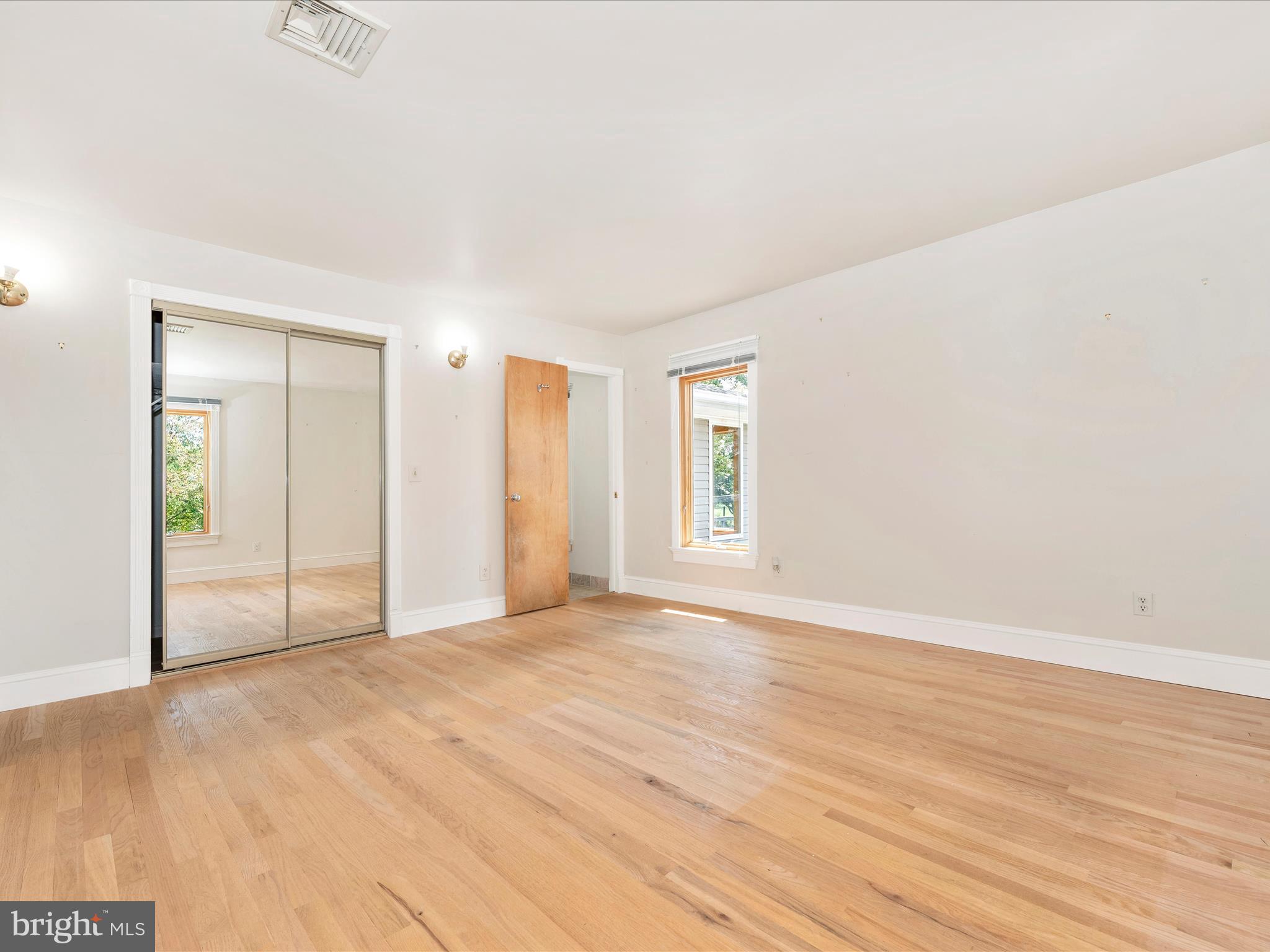 2313 Bidle Road Middletown, MD 21769 - Photo 32 of 85 a view of an empty room with wooden floor and a window
