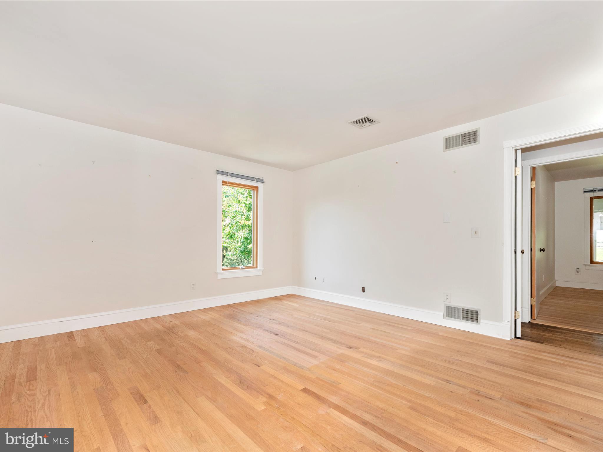 2313 Bidle Road Middletown, MD 21769 - Photo 35 of 85 a view of an empty room with wooden floor and a window