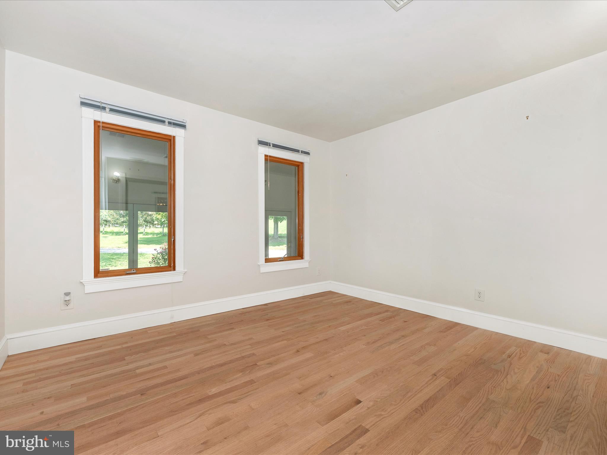 2313 Bidle Road Middletown, MD 21769 - Photo 39 of 85 an empty room with wooden floor and windows