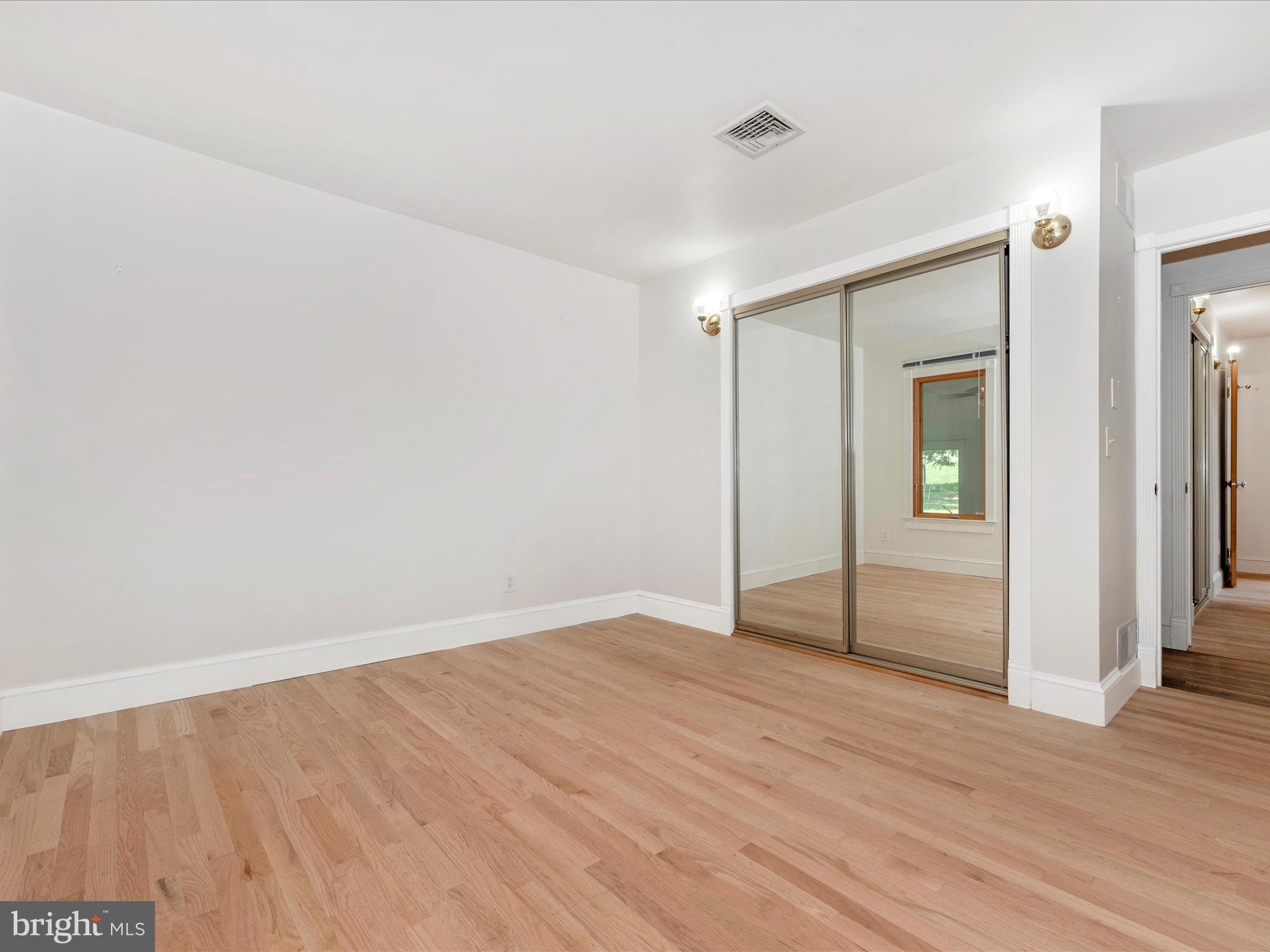 2313 Bidle Road Middletown, MD 21769 - Photo 40 of 85 an empty room with wooden floor and windows