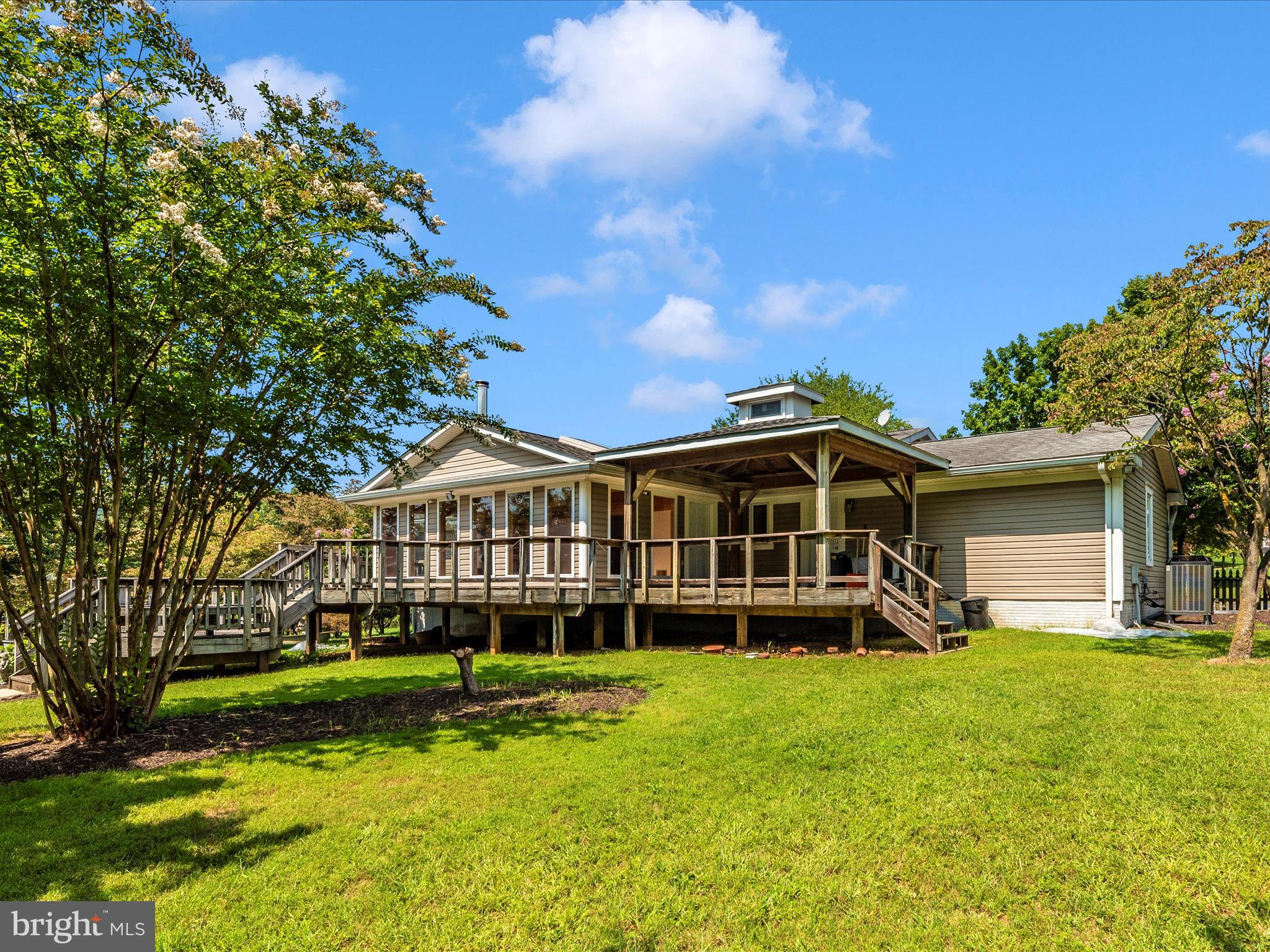 2313 Bidle Road Middletown, MD 21769 - Photo 48 of 85 a view of a house with a yard deck and a large tree
