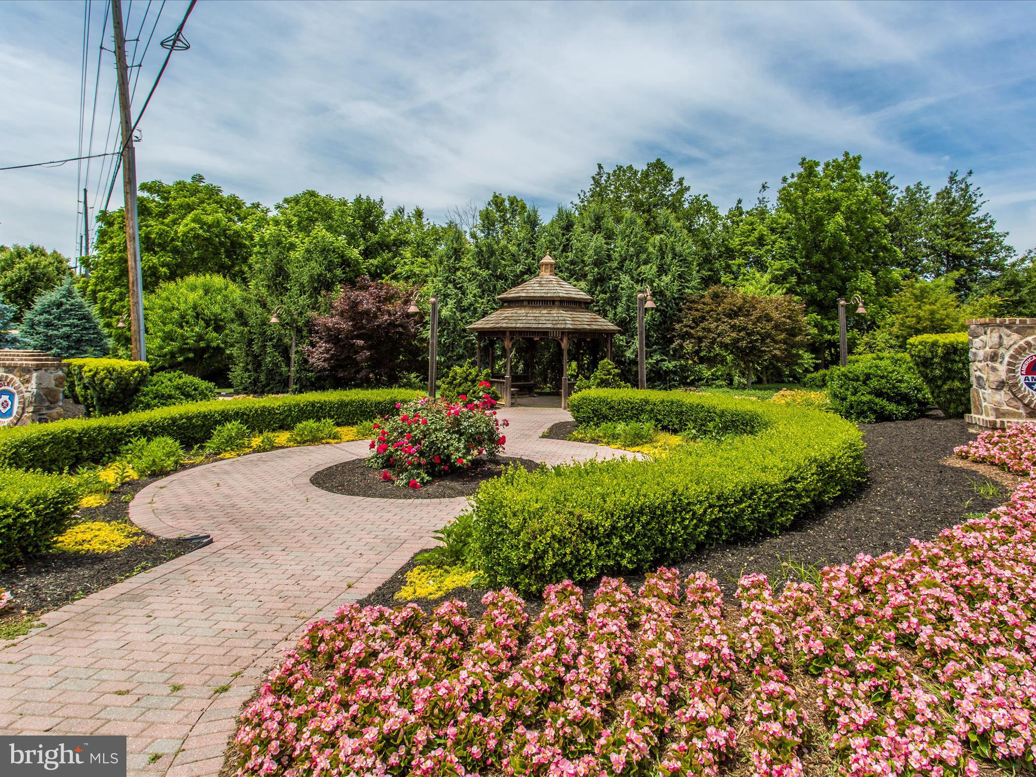 2313 Bidle Road Middletown, MD 21769 - Photo 80 of 85 a view of a garden with a table and chairs under an umbrella