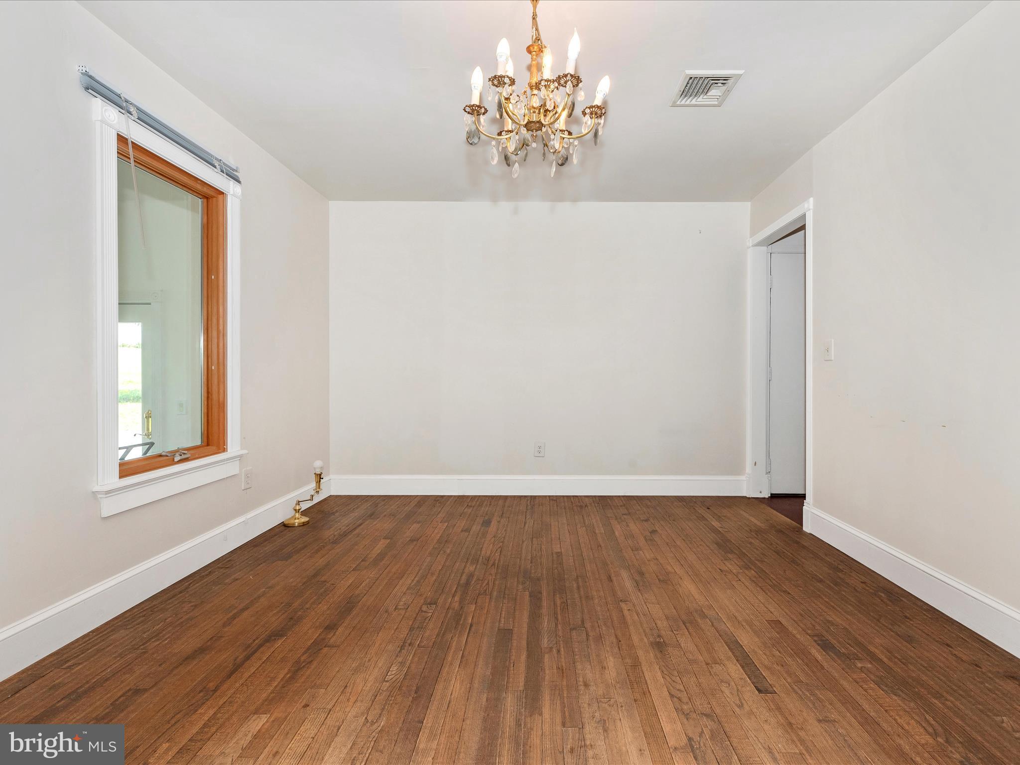 2313 Bidle Road Middletown, MD 21769 - Photo 9 of 85 a view of an empty room with wooden floor and a window