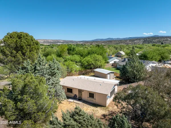 an aerial view of a house with a yard basket ball court and outdoor seating