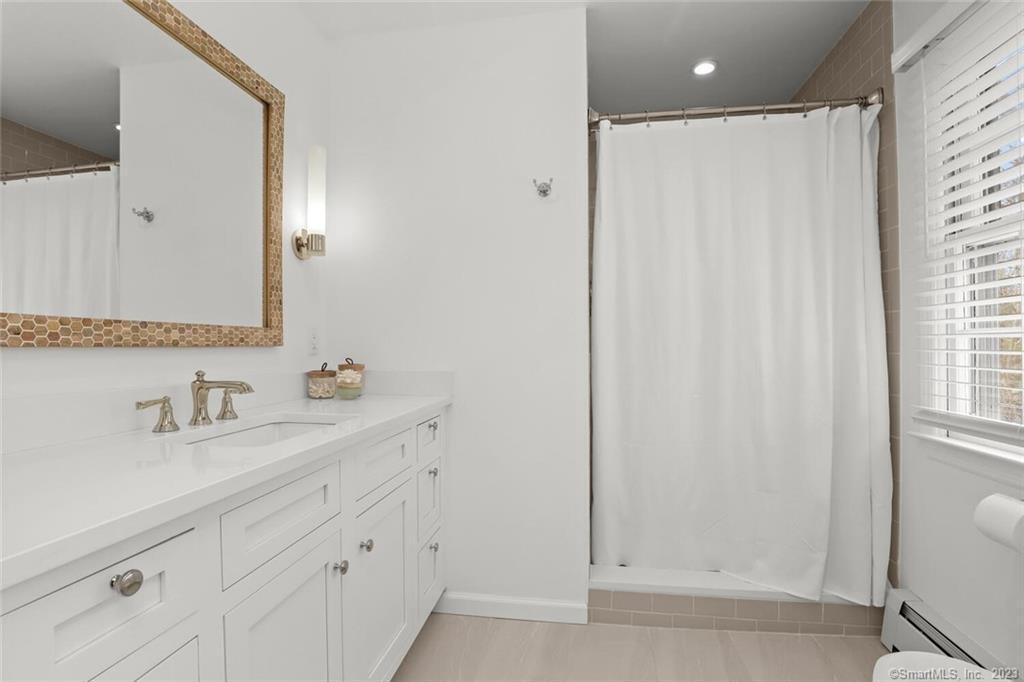 183 Frogtown Road New Canaan, CT 06840 - Photo 17 of 37 a bathroom with a sink and a mirror