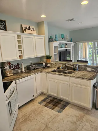 a kitchen with stainless steel appliances granite countertop a stove and a sink