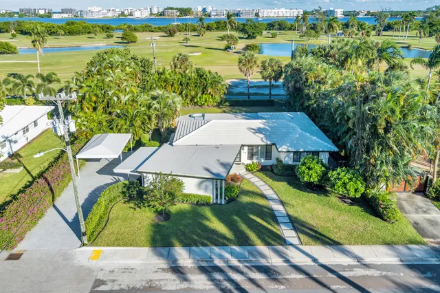 an aerial view of a house with outdoor space pool patio and lake view