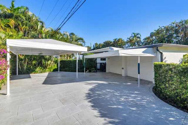 a view of a house with backyard and a floor to ceiling window