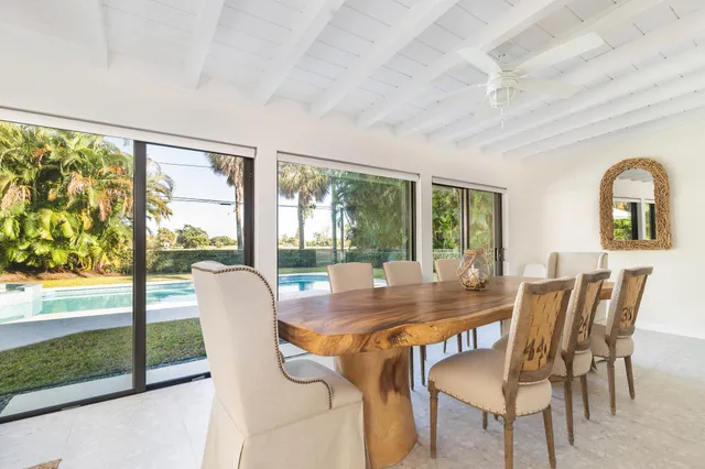 a dining room with furniture window and outside view
